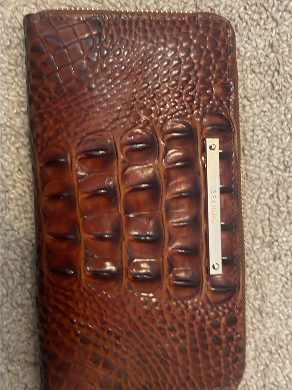 appears to be the Brahmin Suri Melbourne Leather Zip-Around Wallet
MSRP $195